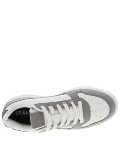 Sneakers en cuir blanc à logo siliconé jaune débossé à l'extérieur de la tige