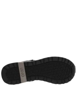 Sneakers montantes en cuir brillant noir à semelle running compensée et soufflets élastiqués