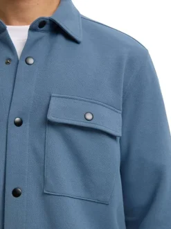 Surchemise bleue uni avec un col boutonné et des manches longues