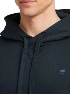 Sweat à capuche marine uni avec une poche kangourou et une coupe droite