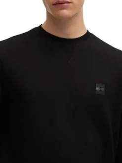 Sweat en coton noir uni avec une coupe regular fit et un patch à la poitrine