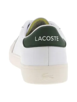 Tennis blanches avec des détails verts à semelle plate et à lacets plats