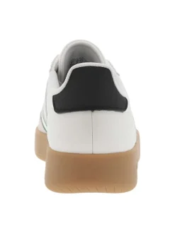 Tennis blanches et vertes en cuir à semelle marron avec logo jaune et lacets