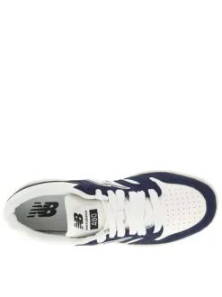 Tennis en cuir blanches et bleu marine avec semelle plate et lacets tressés