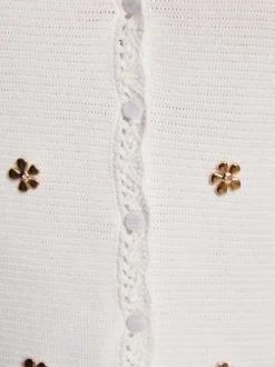 Top blanc uni avec une coupe droite un col v et sans manches