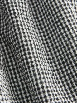 Top en coton noir pourvu d'un motif à carreaux et d'un décolleté bustier