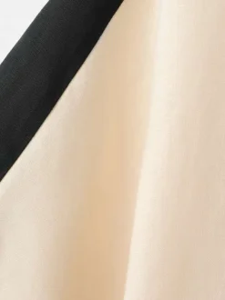 Top en lin beige uni pourvu d'une coupe droite et de manches longues