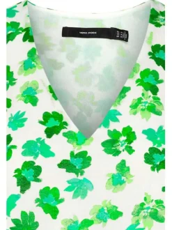Top fleuri vert avec des froufrous et un col V