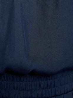 Top marine uni chic pourvu d'une coupe droite et d'un col en V