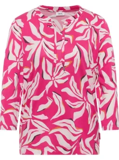 Top rose à motifs pourvu d'un col v à nouer et d'une coupe droite