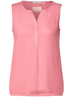 Top rose uni sans manches avec une matière fluide et un col fendu