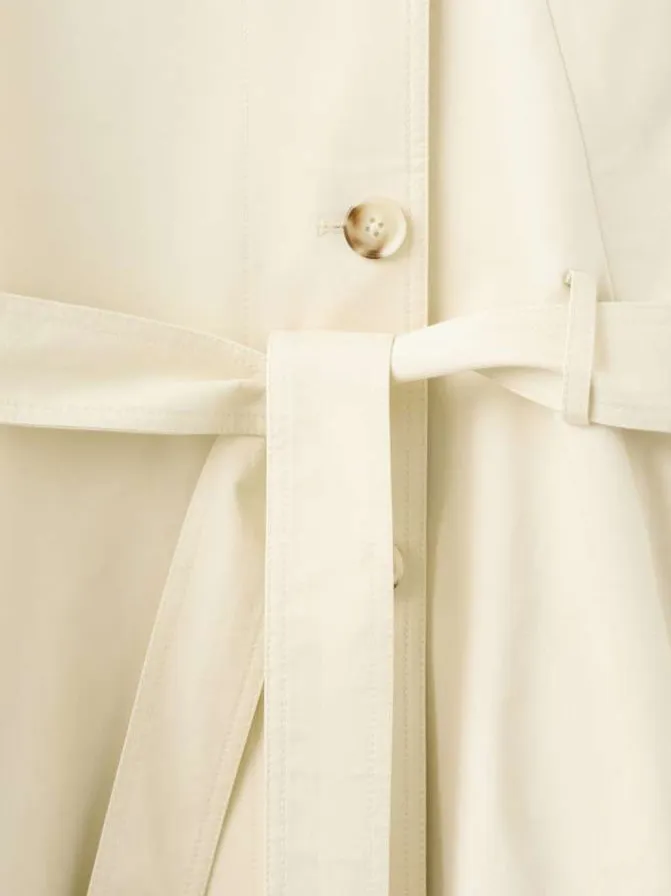Trench coat long en coton beige uni avec une coupe ample et un col montant