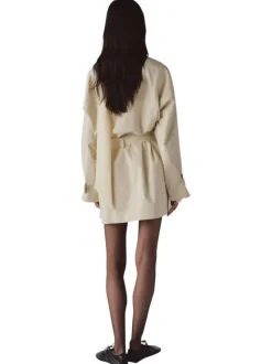 Trench coat long en coton beige uni avec une coupe ample et un col montant