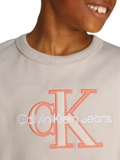 T-shirt en coton beige uni avec un col rond et le nom de la marque brodé en gros