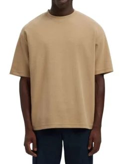T-shirt beige uni coupe ample avec un col rond et des manches courtes