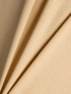 T-shirt en coton beige uni pourvu d'un col rond et de manches courtes