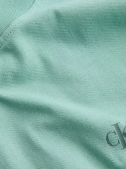 T-shirt en coton bleu turquoise à col rond avec un gros imprimé au dos
