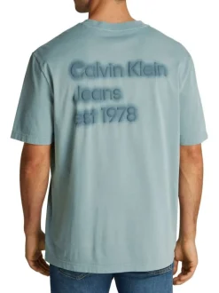 T-shirt en coton bleu uni à coupe oversize avec une écriture gaufrée à l'arrière