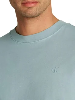 T-shirt en coton bleu uni à coupe oversize avec une écriture gaufrée à l'arrière