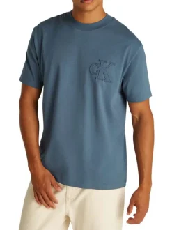 T-shirt en coton bleu uni à coupe oversize avec un patch logo cousu à l'avant