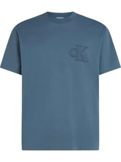 T-shirt en coton bleu uni à coupe oversize avec un patch logo cousu à l'avant
