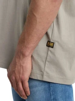 T-shirt en coton gris uni avec une coupe droite et un patch d'authenticité