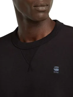 T-shirt en coton noir uni avec logo iconique sur la poitrine et un col rond