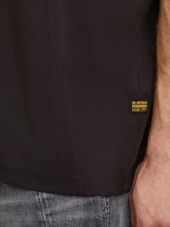 T-shirt en coton noir uni avec un col rond et un patch d'authenticité