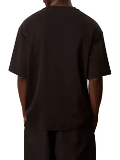 T-shirt en coton noir uni à coupe oversize avec le nom de la marque brodé