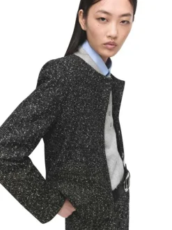 Veste noire en maille jaspée avec une coupe droite et un col rond