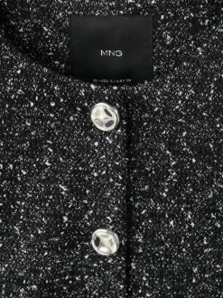 Veste noire en maille jaspée avec une coupe droite et un col rond