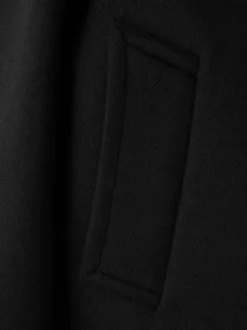 Veste noire unie avec une coupe oversize et des manches longues